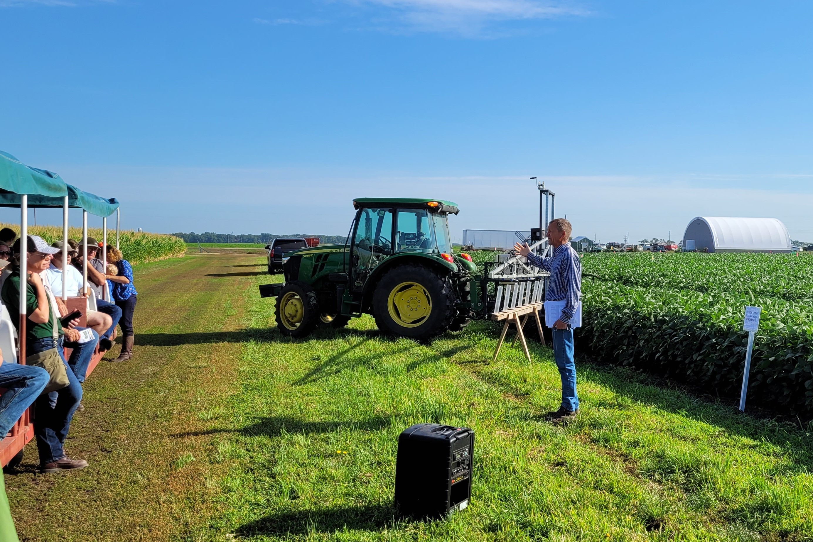 Tractor and sprayer near research plots