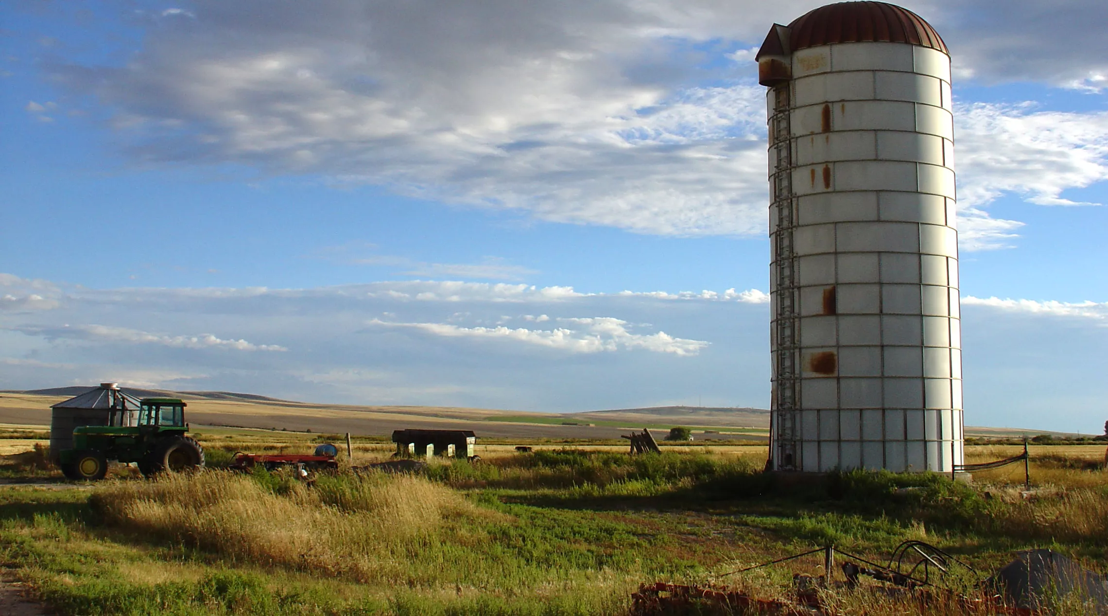 Old silo and farm with a blue sky