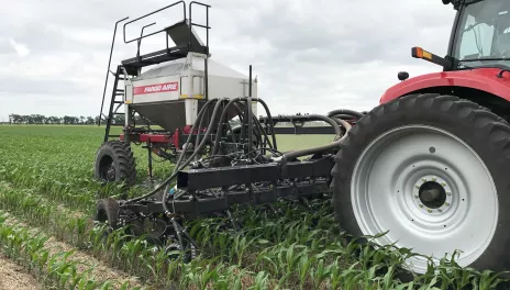 red tractor in field with cover crops