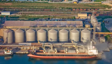 Grain being loaded onto large cargo ship.