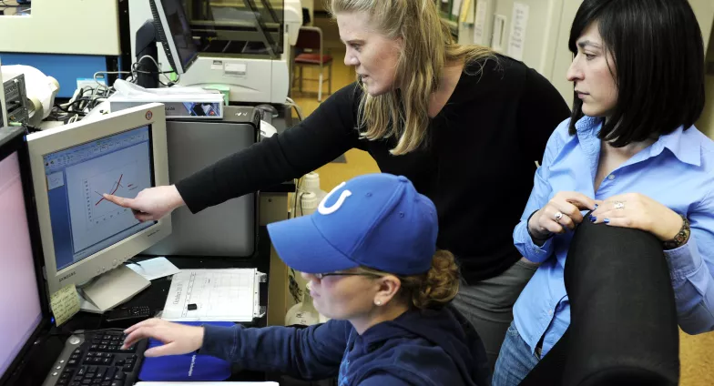 Professor and students doing research in lab