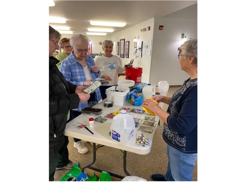 A group of senior citizens planting seeds