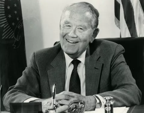 Quentin Burdick poses sitting down at a desk