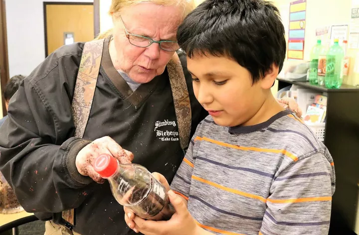 agent mentoring youth during science camp