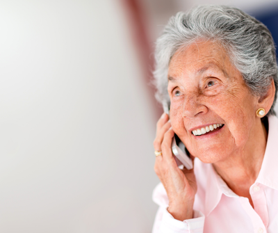 Elderly woman on her cell phone smiling