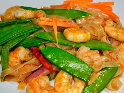 Close up of plated shrimp and snow pea stir fry