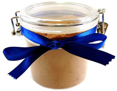Clear jar with a blue ribbon at the top containing a beverage mix
