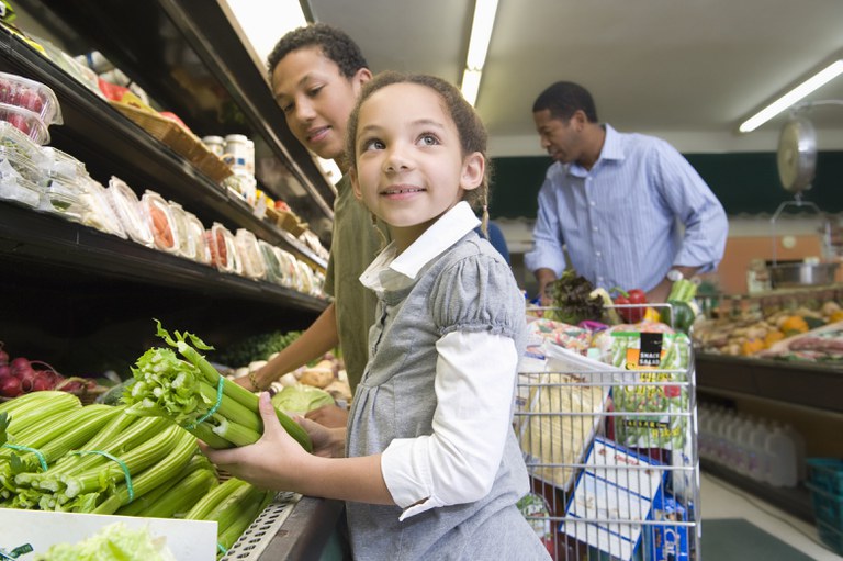 Boy, girl and man shopping in a grocery store