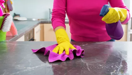 woman cleaning kitchen counter