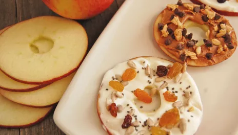 Apple Dough-less Donuts, prepared and presented on a platter with apple slices nearby