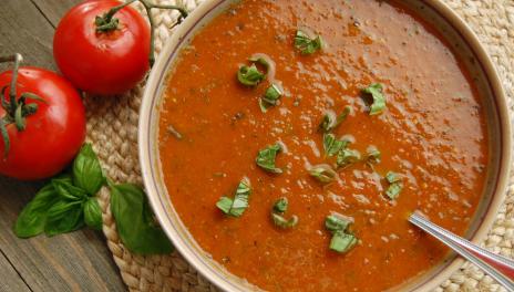 Rustic Tomato Basil Soup, prepared and served in a bowl with basil leaves on top