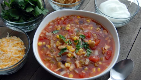 Slow Cooker Chicken Tortilla Soup, served with sour cream, cheese, cilantro and chips