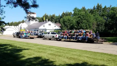 Three trailers, loaded with people 