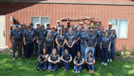 A group of people stand in front of the Carrington REC headquarters.