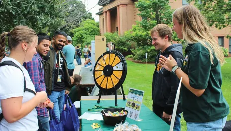 Ag Ambassadors at a table with a game helping recruit students