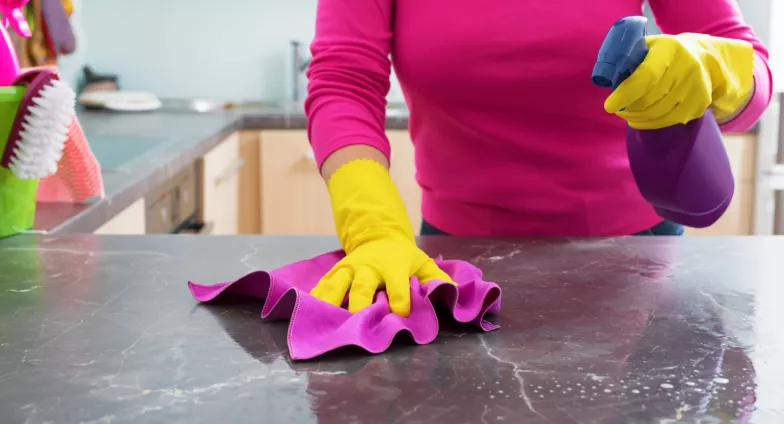 woman cleaning kitchen counter