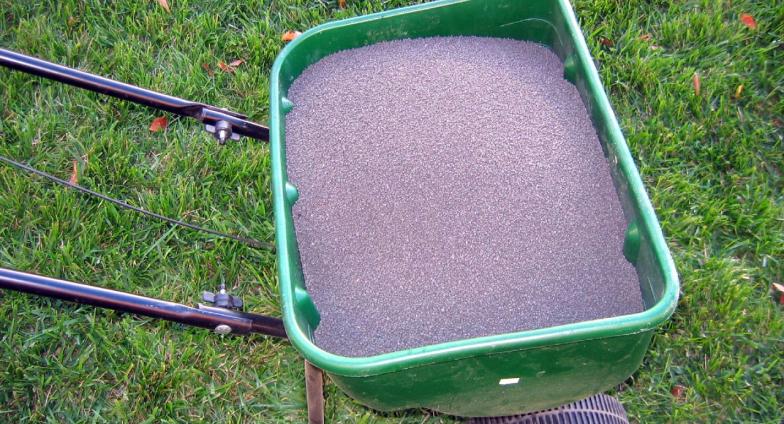 fertilizer spreader with fertilizer granules.