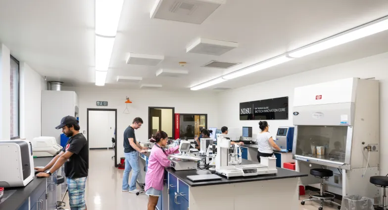 Photo of graduate students working in our renovated core lab.